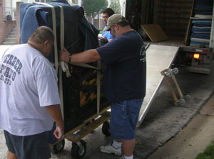 Gerber's Kansas City Piano Mover team loading a piano on a truck